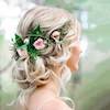 Lady with decorative flowers on her blonde hair looking away from camera